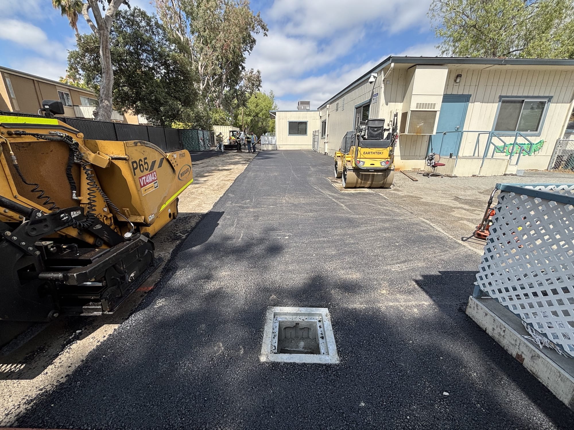 crew and paver placing asphalt