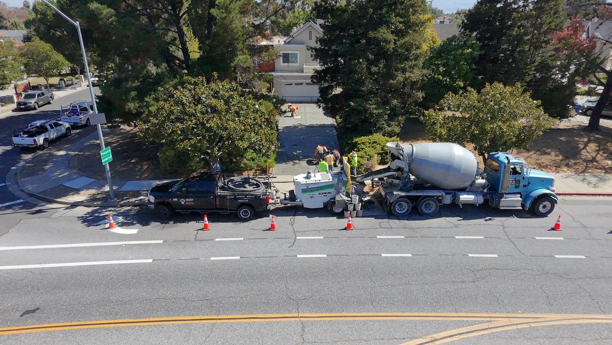 pump truck and mixer staged at the street