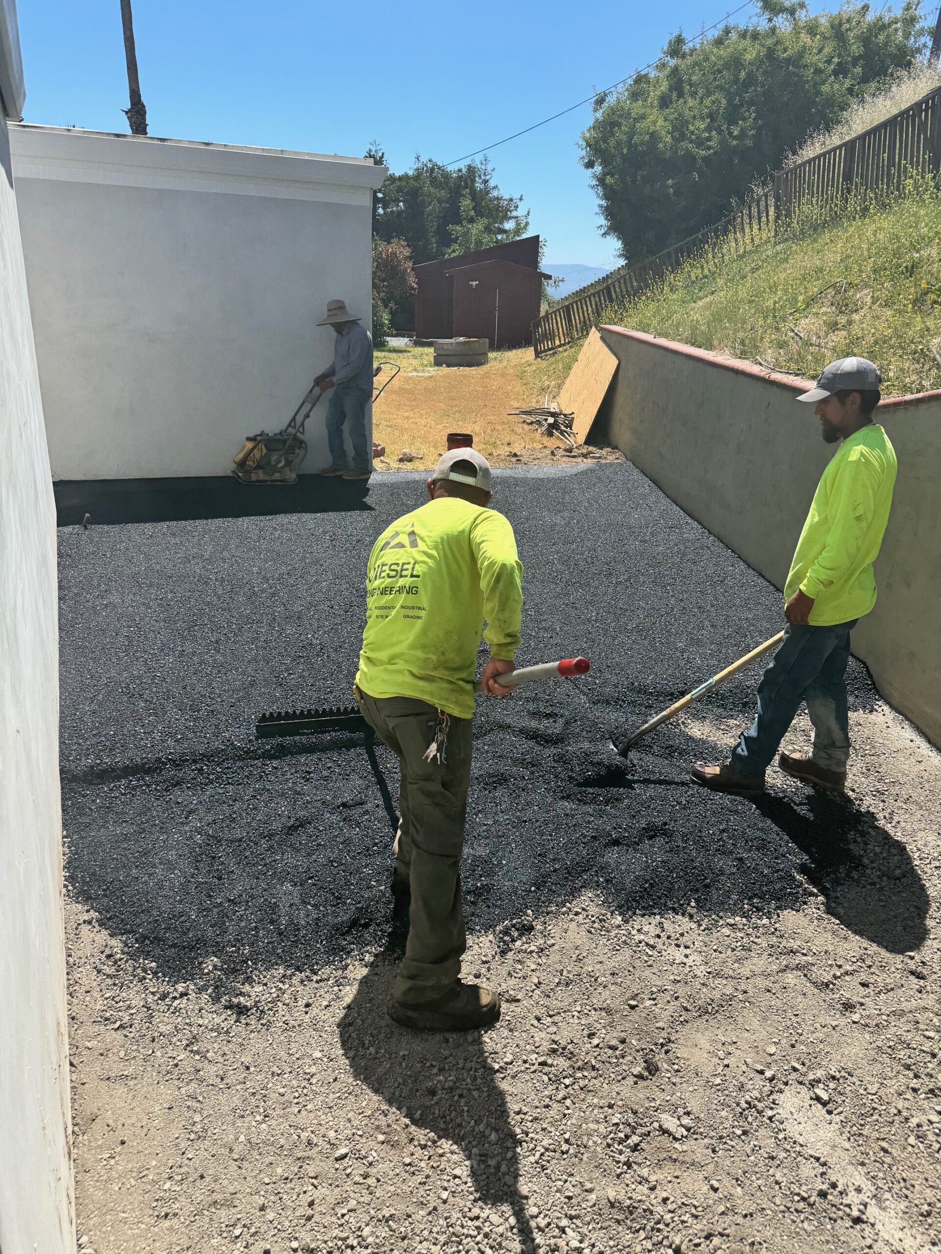 crew paving and rolling the driveway