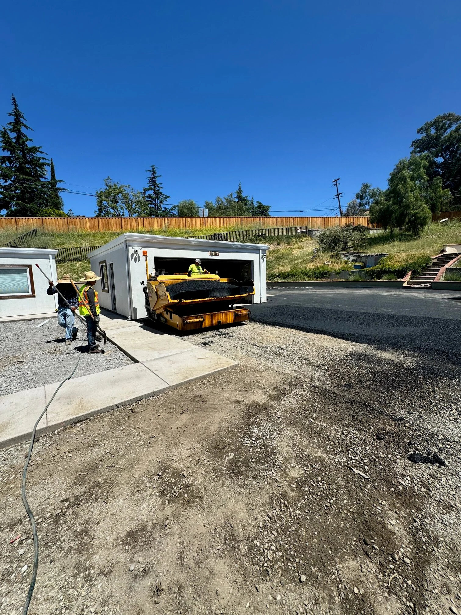before photo — old cracked driveway or unpaved surface