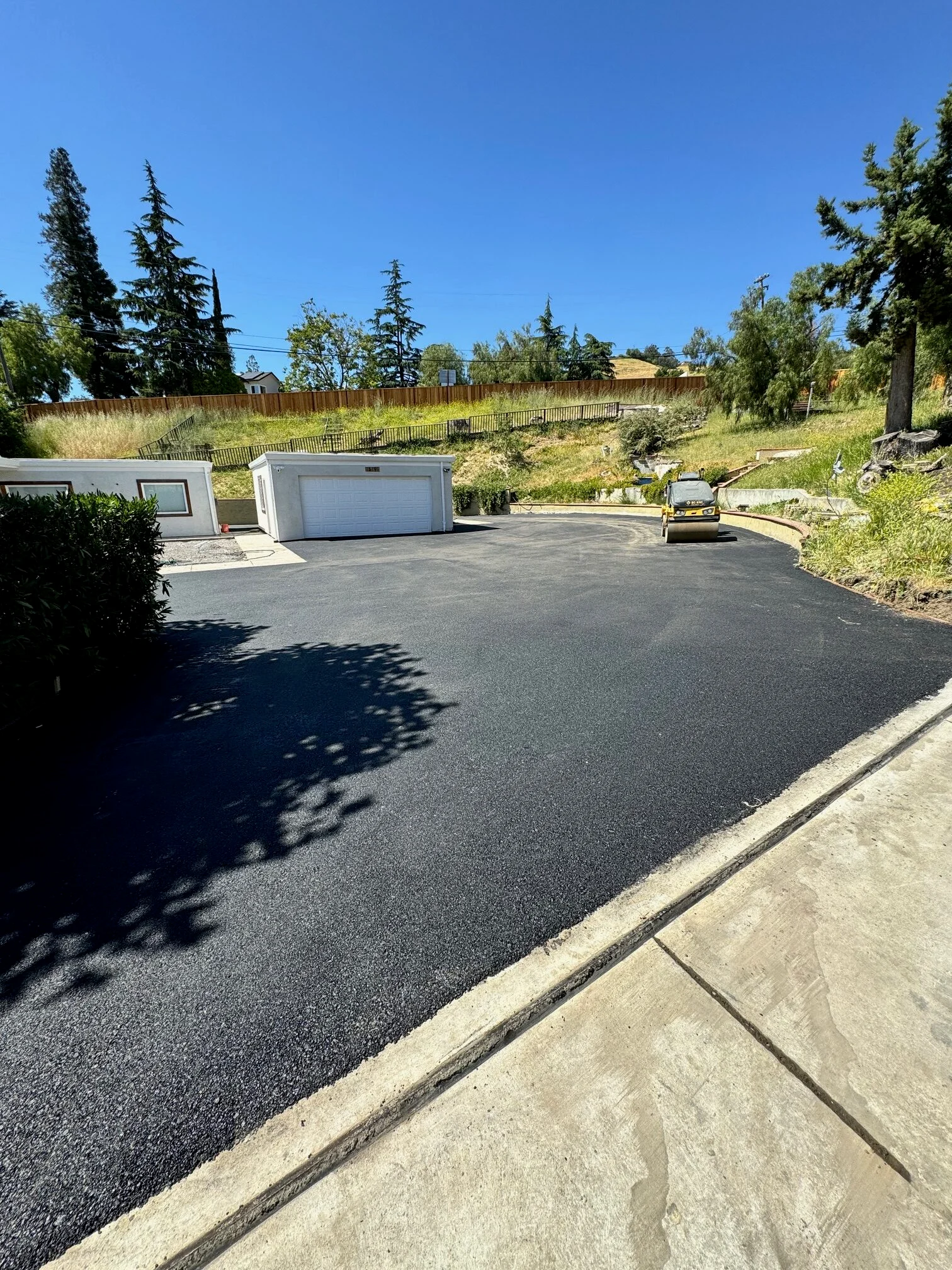 after photo, wide shot of finished driveway with the home