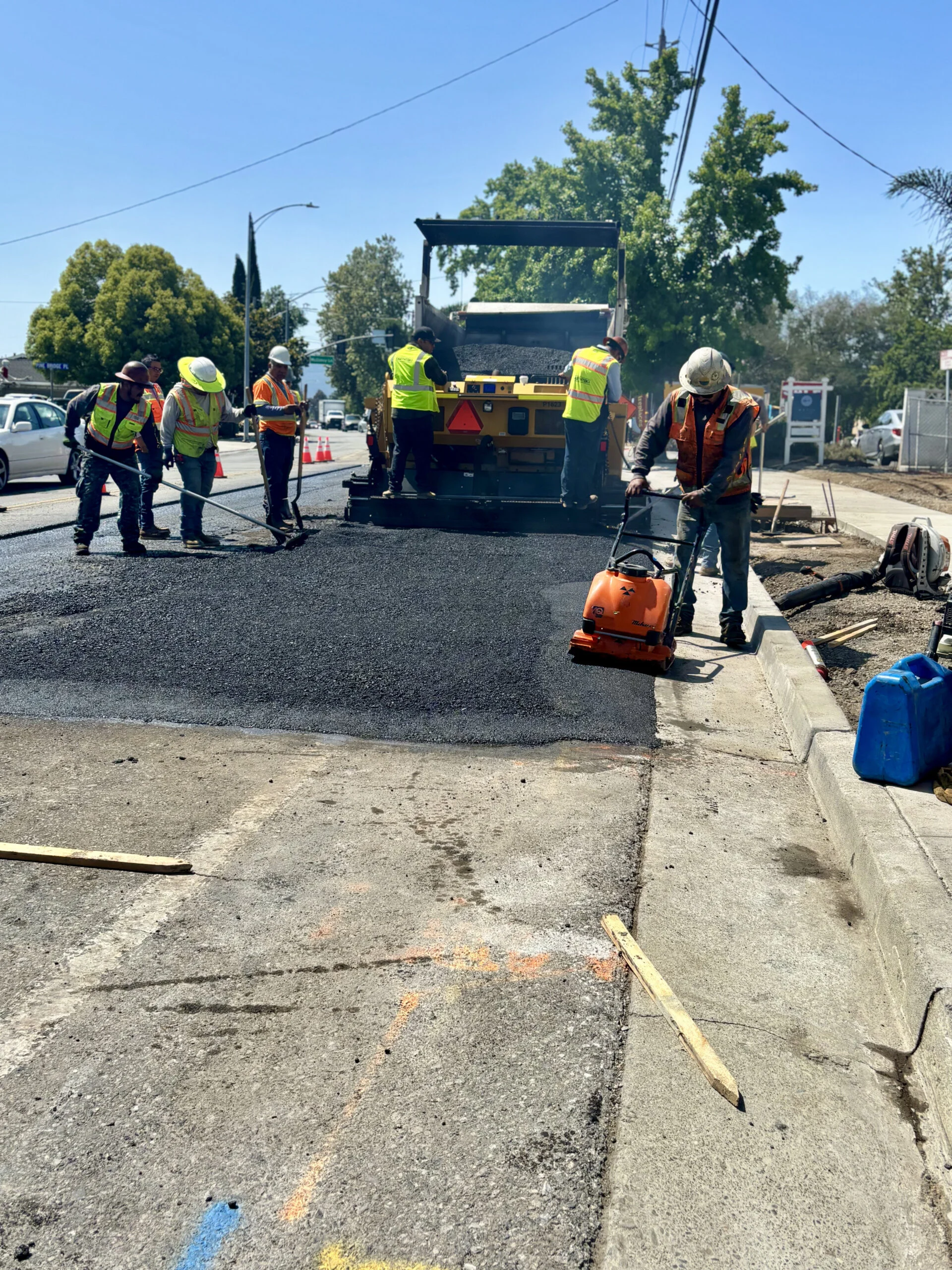crew and paver laying hot mix asphalt