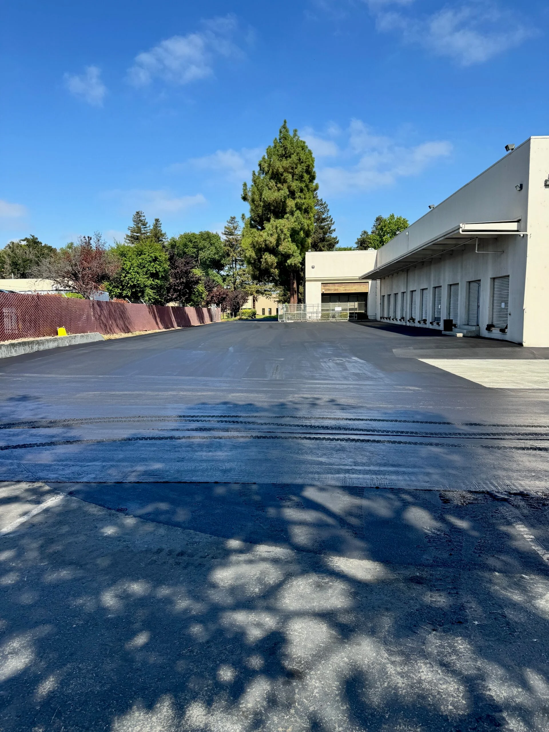 sealcoat being sprayed/squeegeed